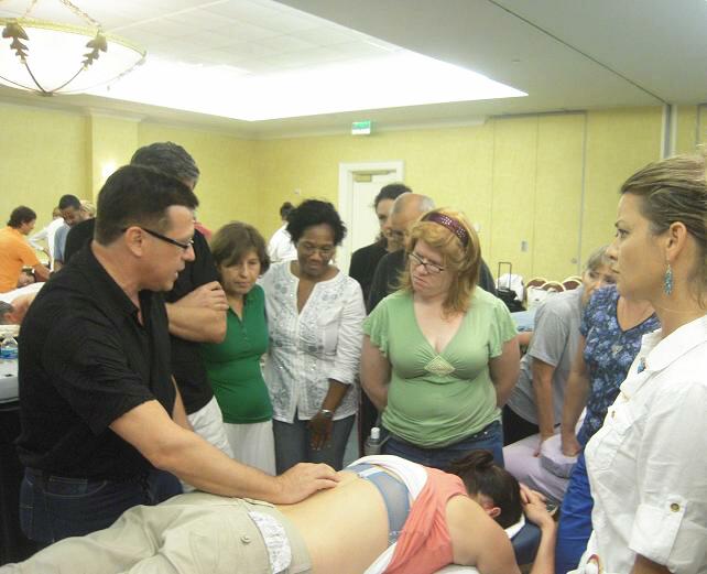 Dr. Ross Turchaninov gives a short review of the sports massage technique before the hands-on training